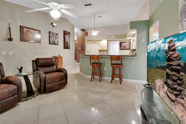 tiled living room featuring ceiling fan and lofted ceiling