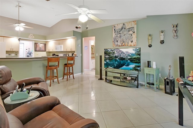 tiled living room with ceiling fan and vaulted ceiling