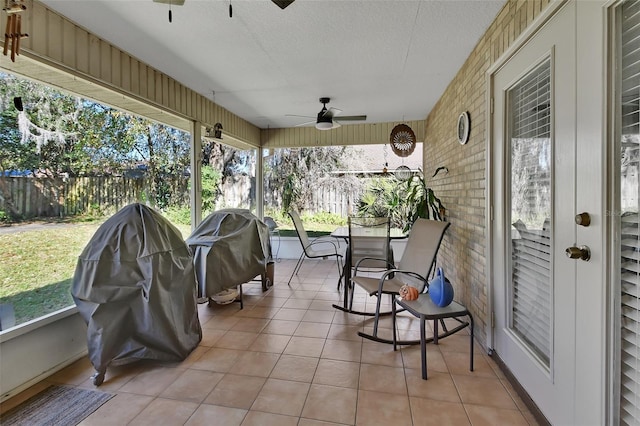 sunroom featuring ceiling fan