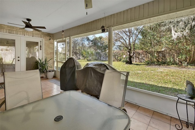 sunroom with ceiling fan and french doors