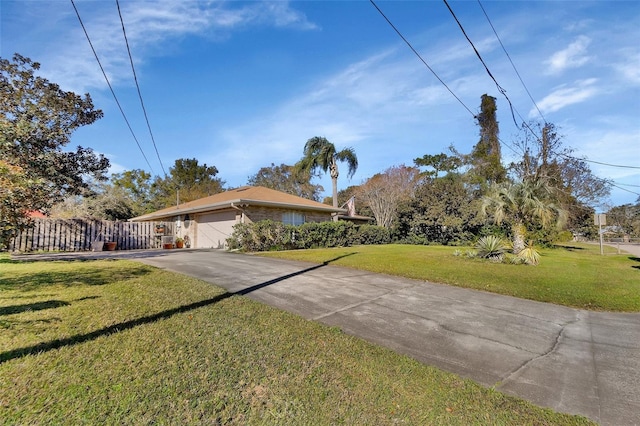 single story home with a front yard and a garage