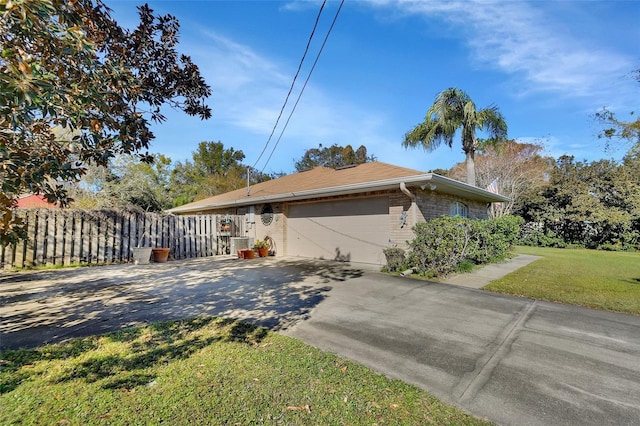 view of front of house featuring a garage and a front lawn