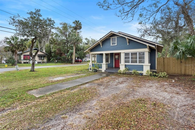 bungalow featuring a porch and a front lawn