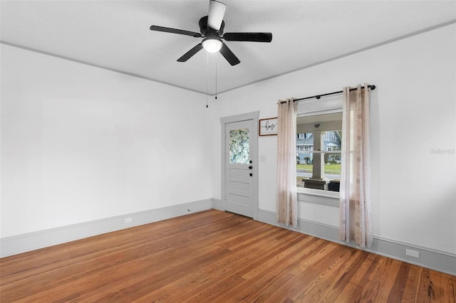 spare room with ceiling fan and wood-type flooring