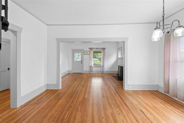 interior space with light hardwood / wood-style flooring and a textured ceiling