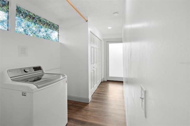 laundry room with dark hardwood / wood-style flooring, a textured ceiling, and washer / clothes dryer