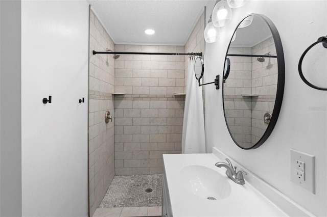 bathroom featuring a textured ceiling, a shower with curtain, and sink