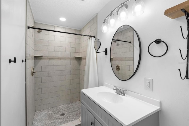 bathroom with vanity, a textured ceiling, and curtained shower