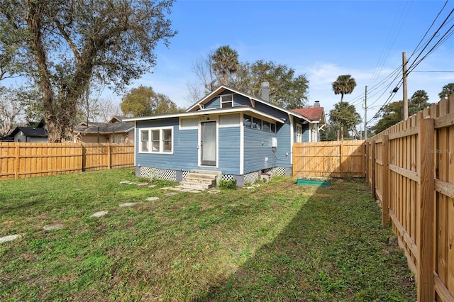 back of house featuring a yard