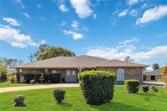 ranch-style home featuring a front yard