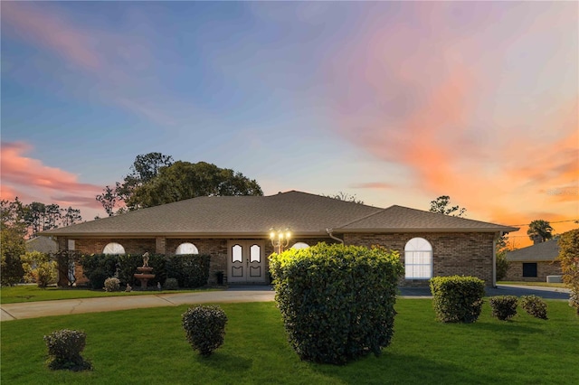 ranch-style house with a yard