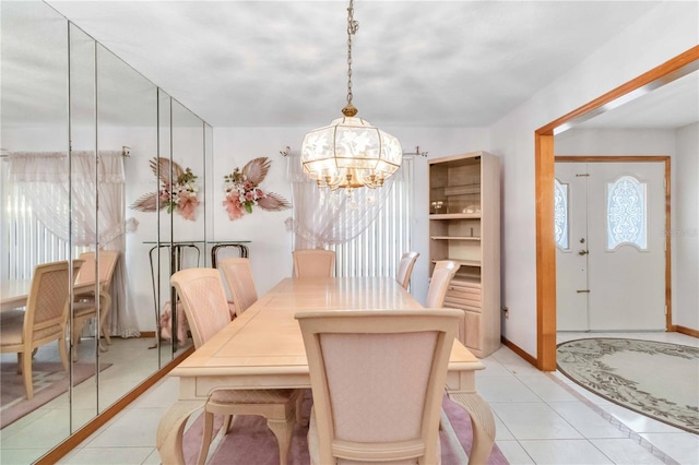 tiled dining space with a notable chandelier