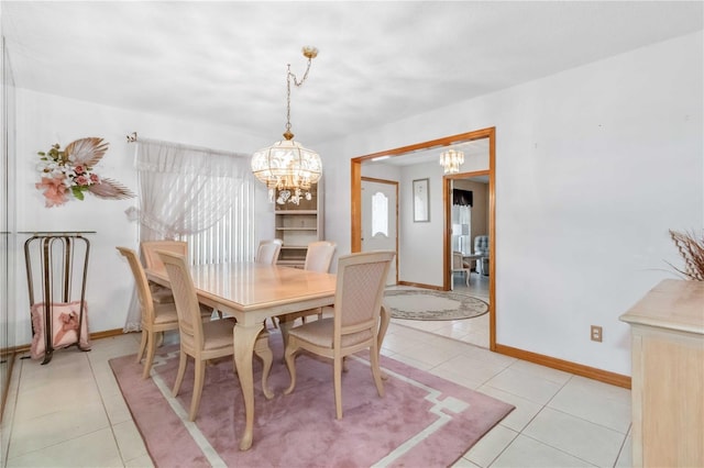 tiled dining area with a chandelier