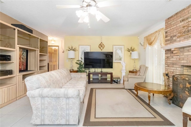 tiled living room featuring ceiling fan, a textured ceiling, and a brick fireplace