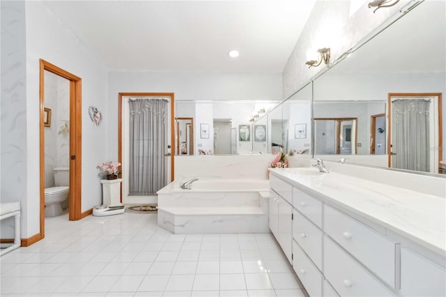 bathroom featuring a bathing tub, tile patterned flooring, vanity, and toilet