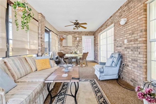 sunroom featuring ceiling fan