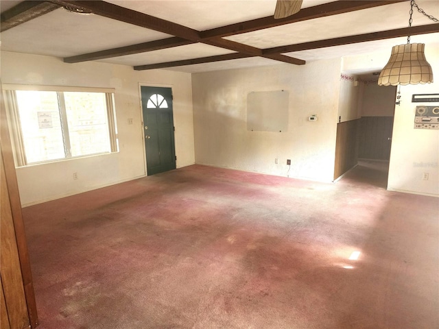 interior space with carpet floors and beamed ceiling