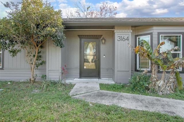 doorway to property with a yard