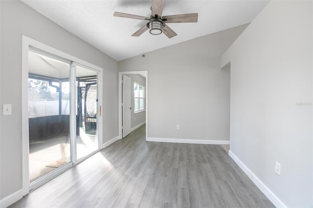 unfurnished room with ceiling fan, lofted ceiling, light hardwood / wood-style flooring, and a textured ceiling