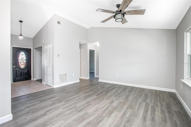 interior space featuring ceiling fan, high vaulted ceiling, and light wood-type flooring