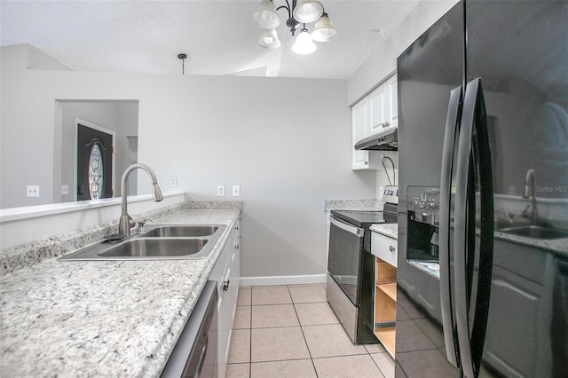 kitchen featuring sink, light tile patterned floors, appliances with stainless steel finishes, white cabinetry, and a chandelier