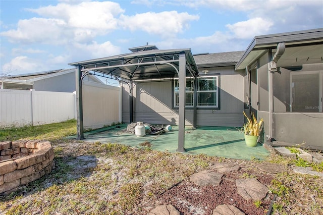 rear view of property featuring a gazebo and a patio