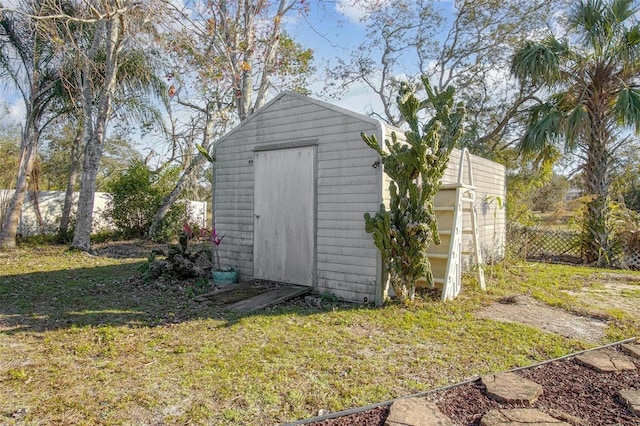 view of outbuilding featuring a lawn