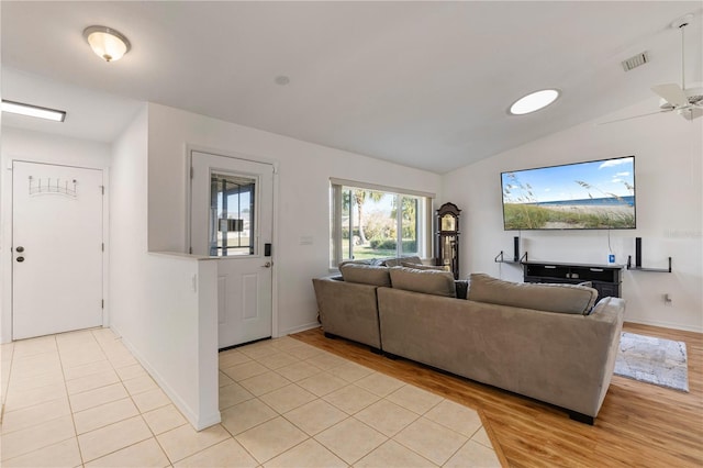 tiled living room featuring vaulted ceiling and ceiling fan