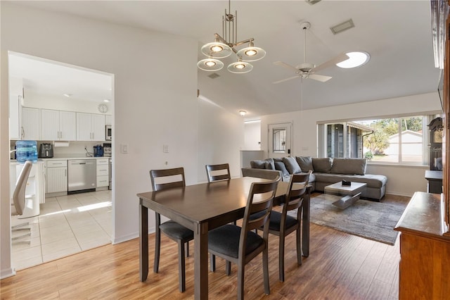 dining area with ceiling fan with notable chandelier and light wood-type flooring