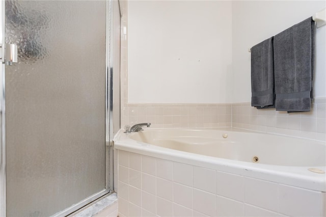 bathroom featuring separate shower and tub