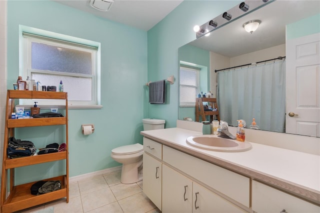 bathroom featuring tile patterned flooring, vanity, and toilet