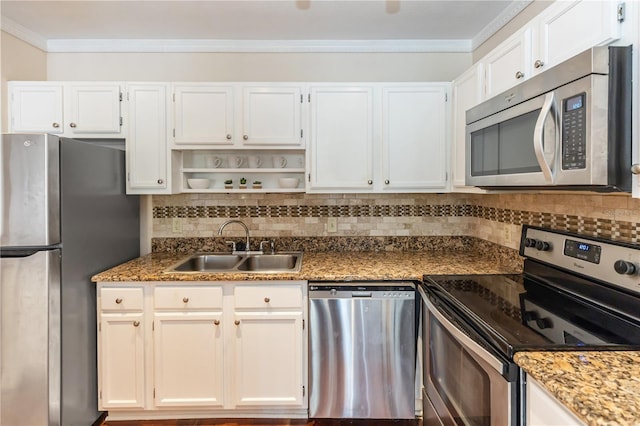 kitchen featuring dark stone counters, sink, white cabinets, and stainless steel appliances