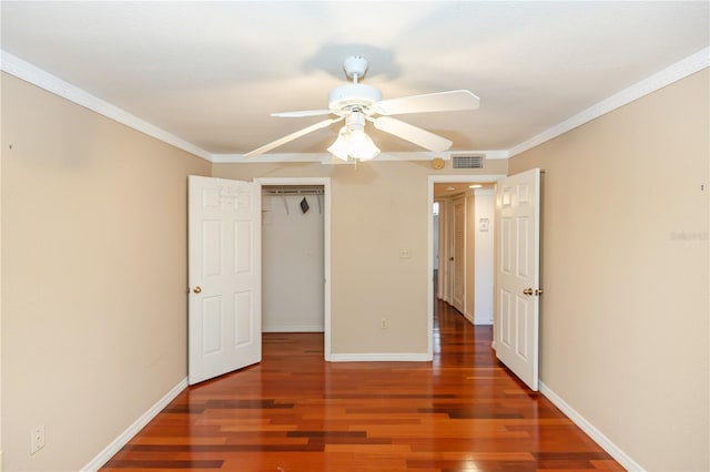 unfurnished bedroom featuring ceiling fan, a closet, dark hardwood / wood-style floors, and ornamental molding