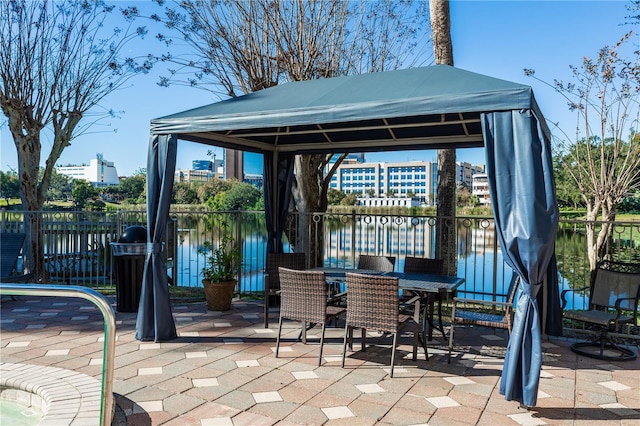 view of patio / terrace with a gazebo and a water view