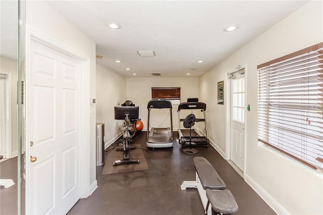 workout room featuring a textured ceiling