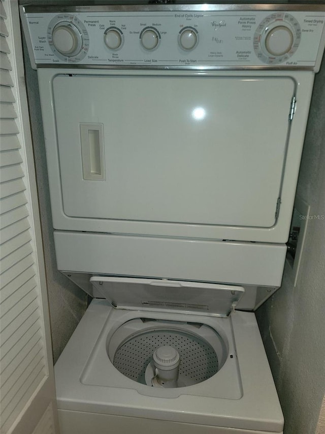 laundry room with stacked washer / drying machine