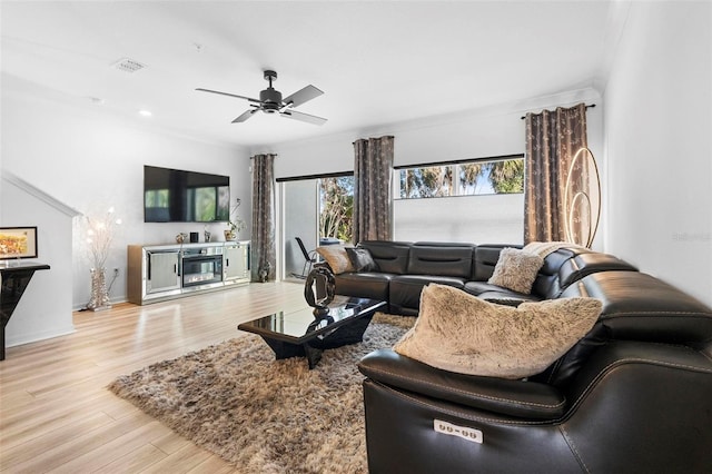 living room featuring ceiling fan and light hardwood / wood-style floors