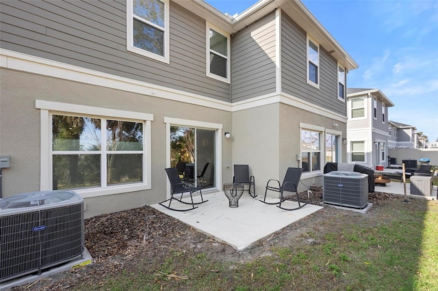 rear view of house featuring a patio area and central air condition unit