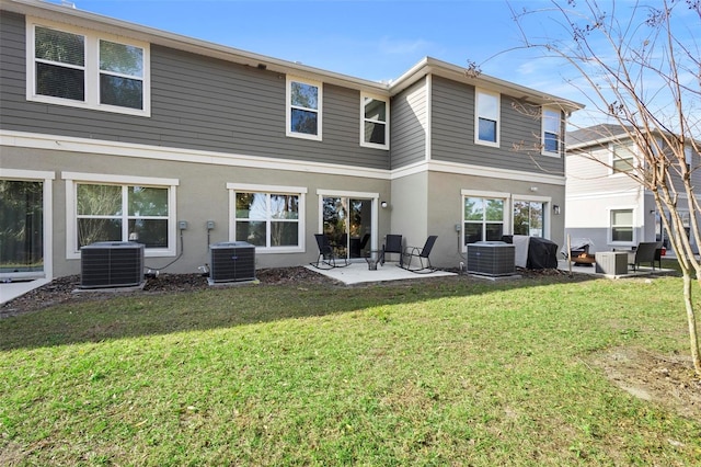 rear view of house featuring central AC, a patio area, and a yard