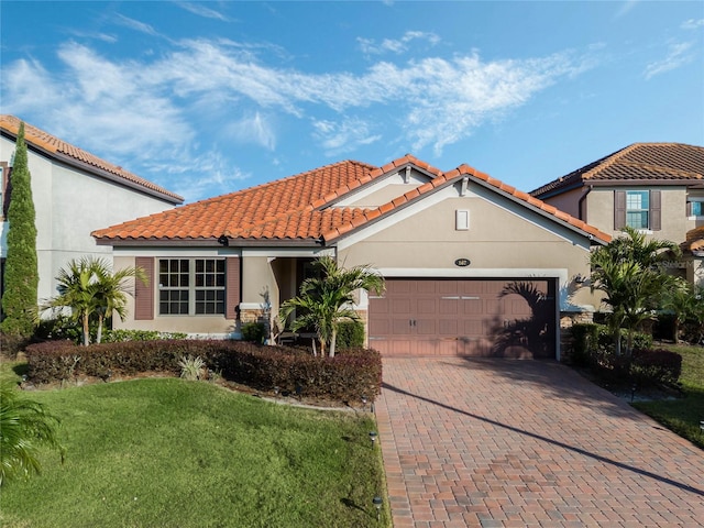 mediterranean / spanish-style house with a front lawn and a garage