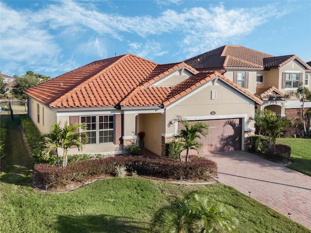 mediterranean / spanish home with a front yard and a garage