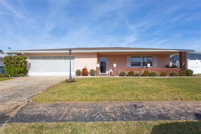 ranch-style home with a garage and a front lawn