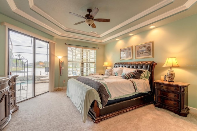 bedroom featuring a tray ceiling, ceiling fan, light carpet, and access to outside