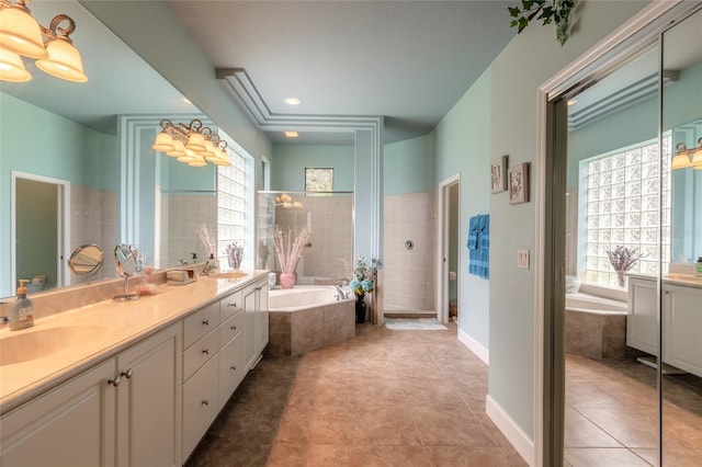 bathroom with tile patterned floors, vanity, and a relaxing tiled tub