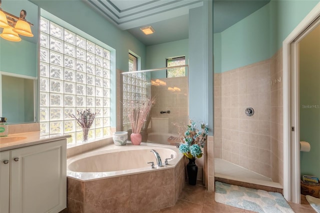 bathroom featuring vanity, tile patterned flooring, and plus walk in shower