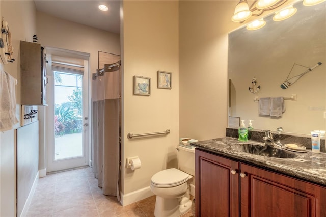 bathroom featuring a wealth of natural light, tile patterned flooring, vanity, and toilet