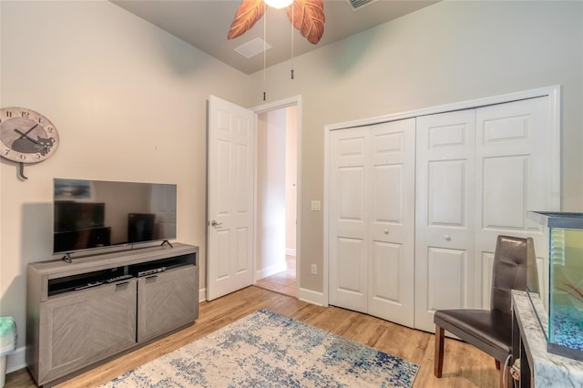 living area featuring ceiling fan and light hardwood / wood-style flooring