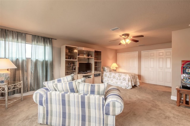 living room featuring ceiling fan and light colored carpet