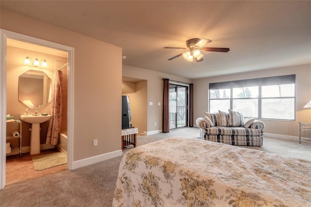 bedroom with ensuite bath, ceiling fan, sink, light colored carpet, and access to outside