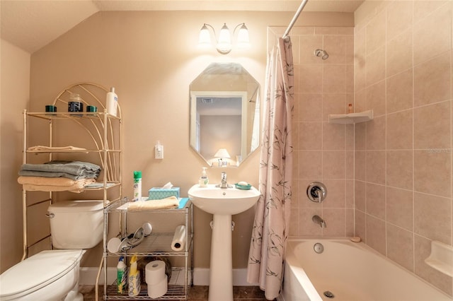 bathroom featuring toilet, shower / tub combo, and vaulted ceiling